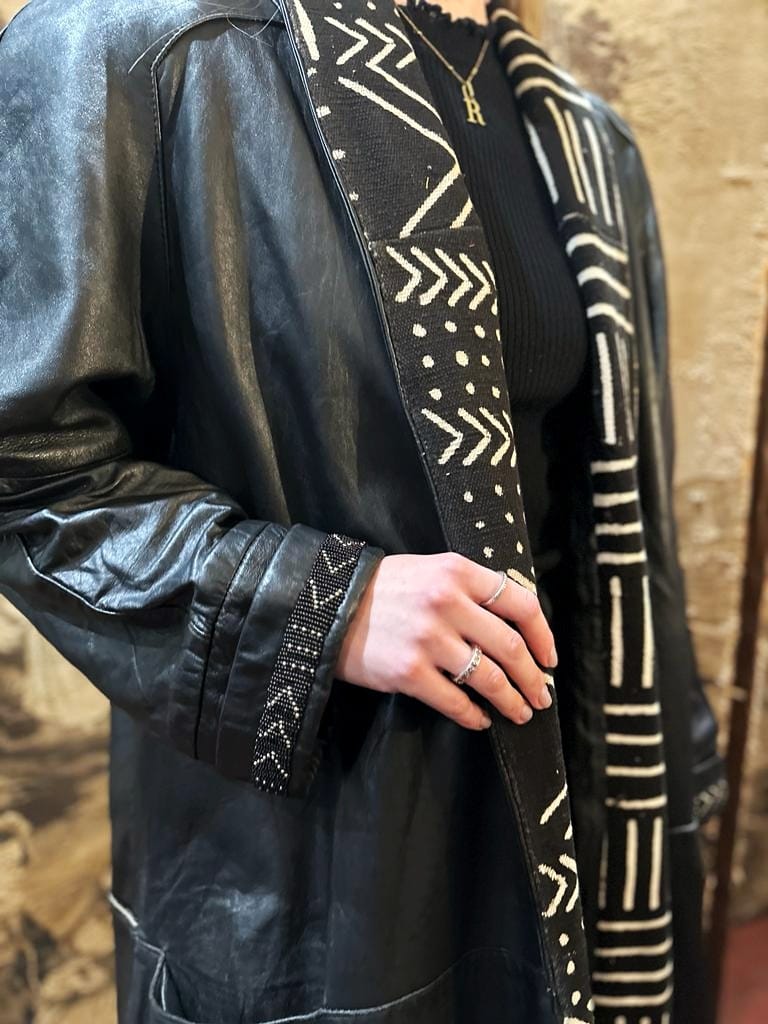 Full length black leather coat.